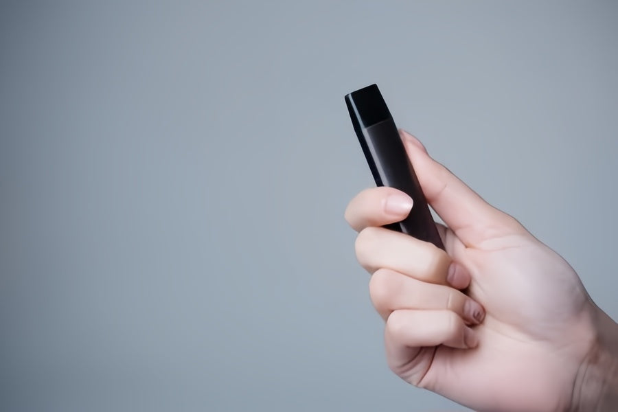 Hold a disposable vape in hand to warm it up